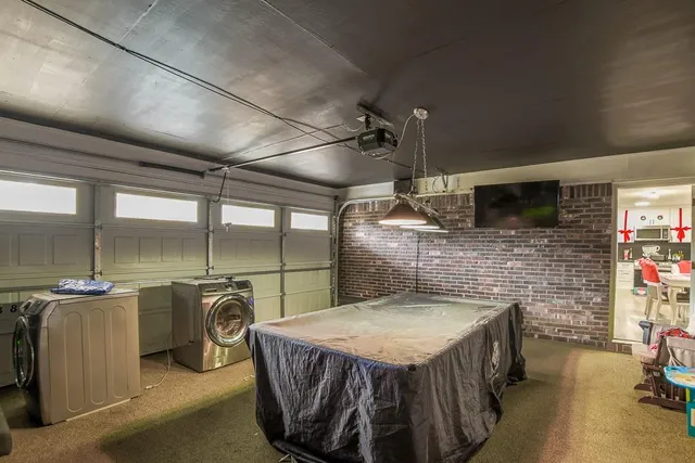 a dining table with chairs and flat screen tv