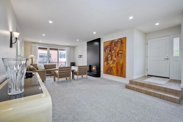 a living room with furniture and white walls