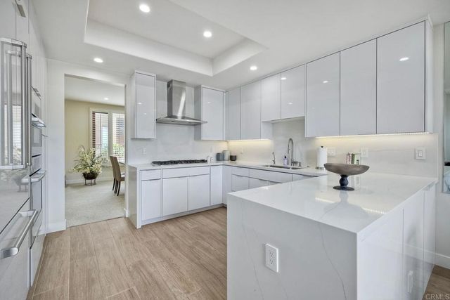 a kitchen with a sink cabinets and wooden floor