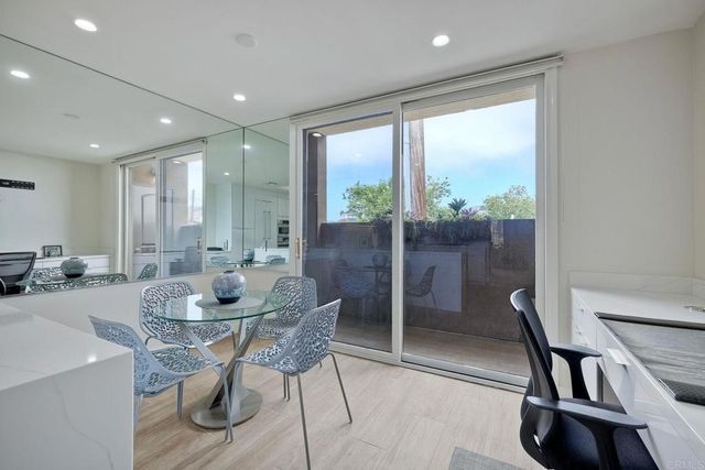 a dining room with furniture and a floor to ceiling window