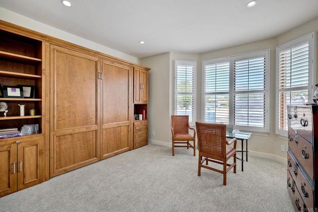 a view of a livingroom with furniture and & window