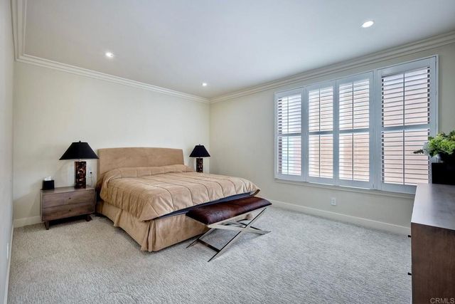 a spacious bedroom with a bed and a large window