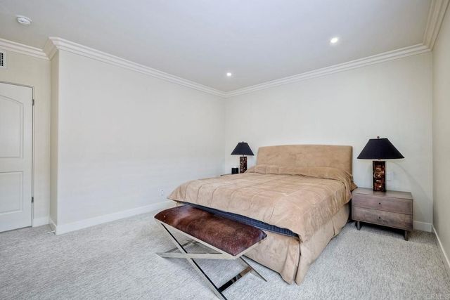 a bedroom with a bed and a lamp