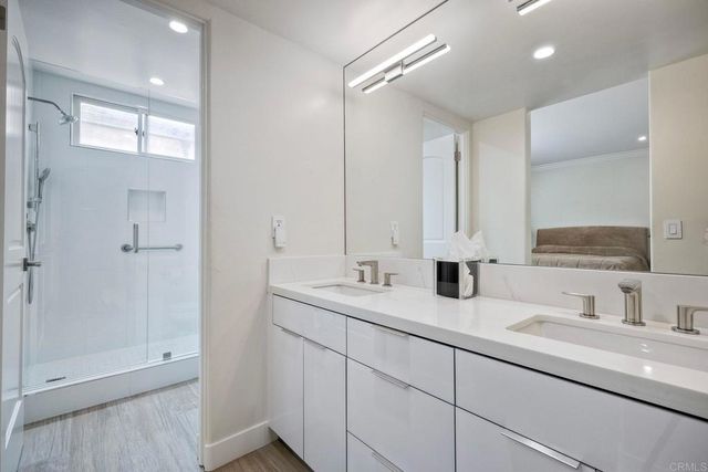 a bathroom with double sink and a mirror