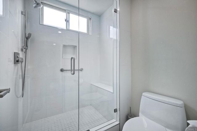 a bathroom with a toilet and a shower