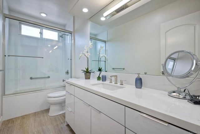 a bathroom with a toilet a sink and mirror