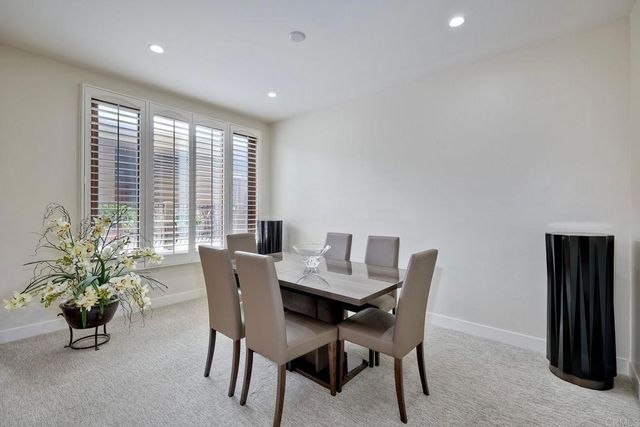 a dining room with furniture and windows