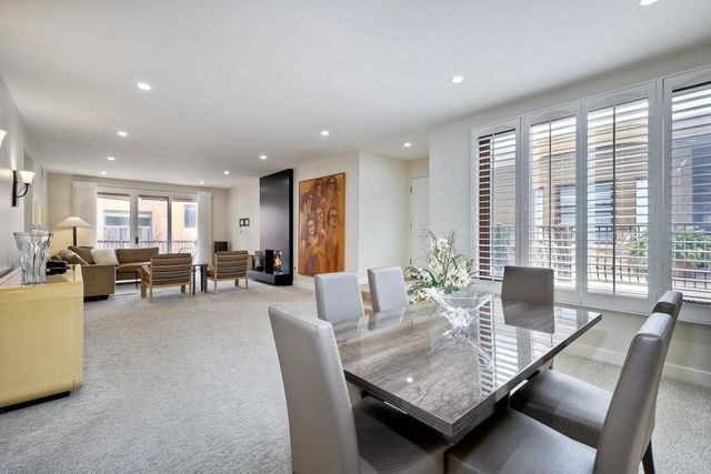 a view of a dining room with furniture and a potted plant