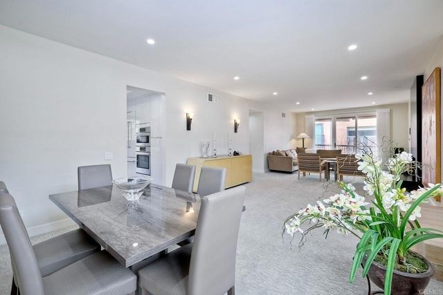 a living room with furniture potted plant and a table