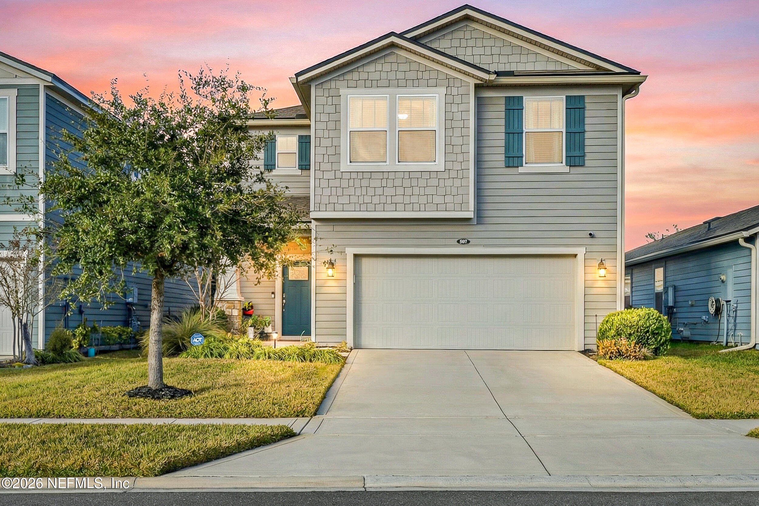 a front view of a house with a yard and garage