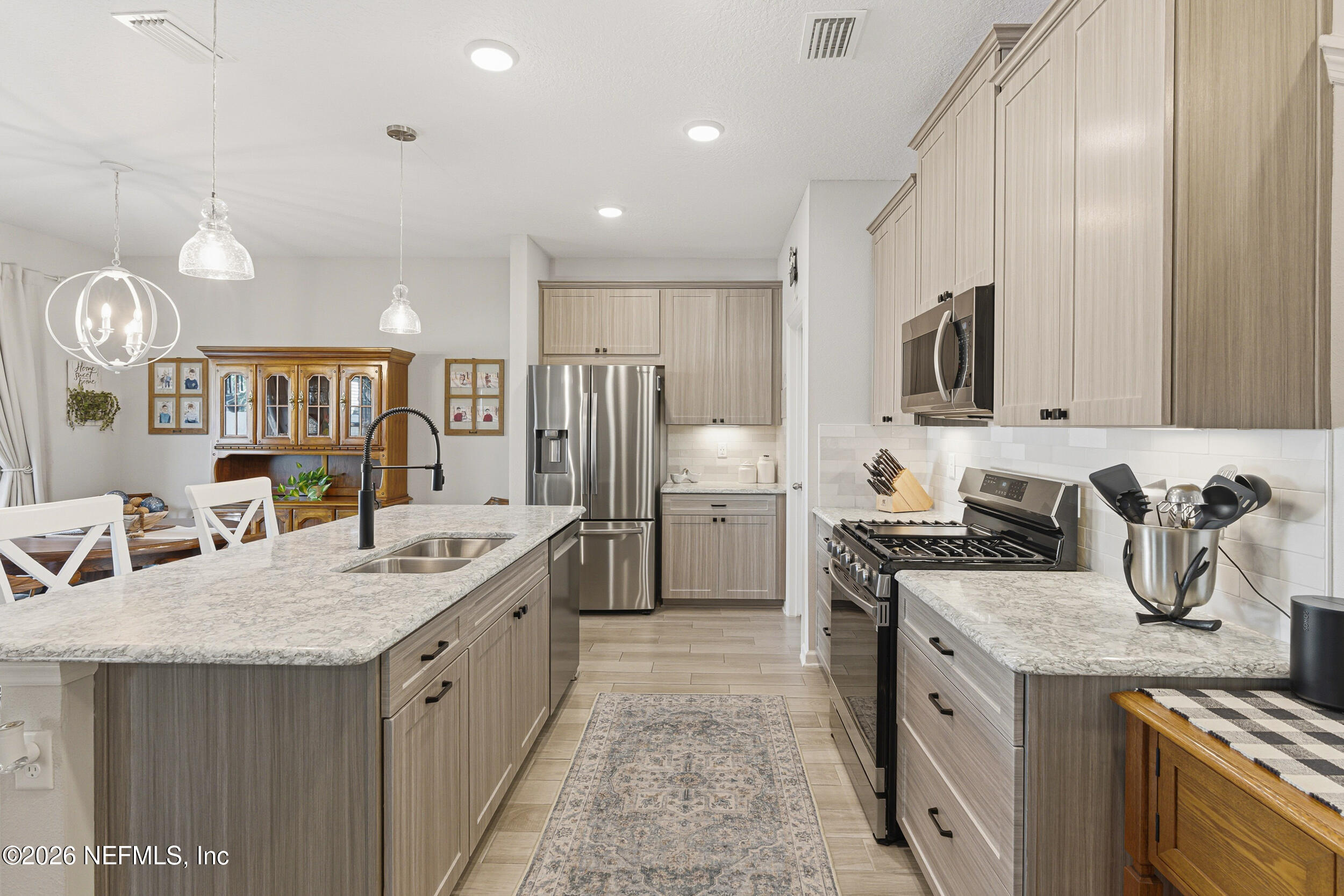 507 Narrowleaf Drive St. Johns, FL 32259 - Photo 10 of 79 a kitchen with stainless steel appliances granite countertop a sink stove and refrigerator