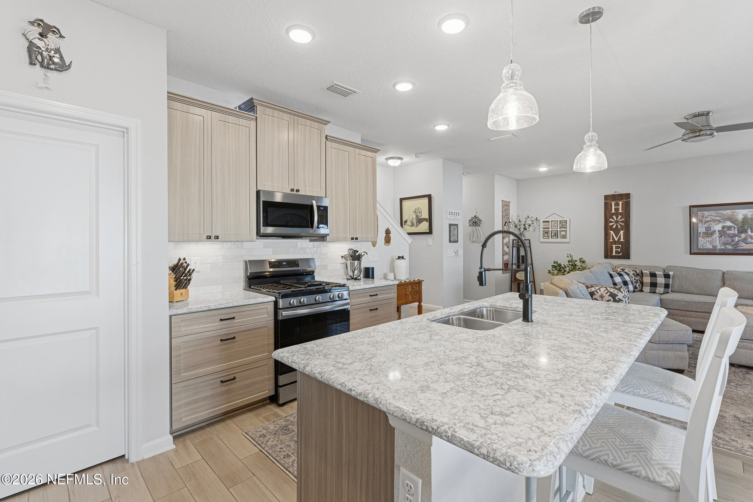 507 Narrowleaf Drive St. Johns, FL 32259 - Photo 11 of 79 a kitchen with stainless steel appliances granite countertop a stove top oven a sink refrigerator and cabinets