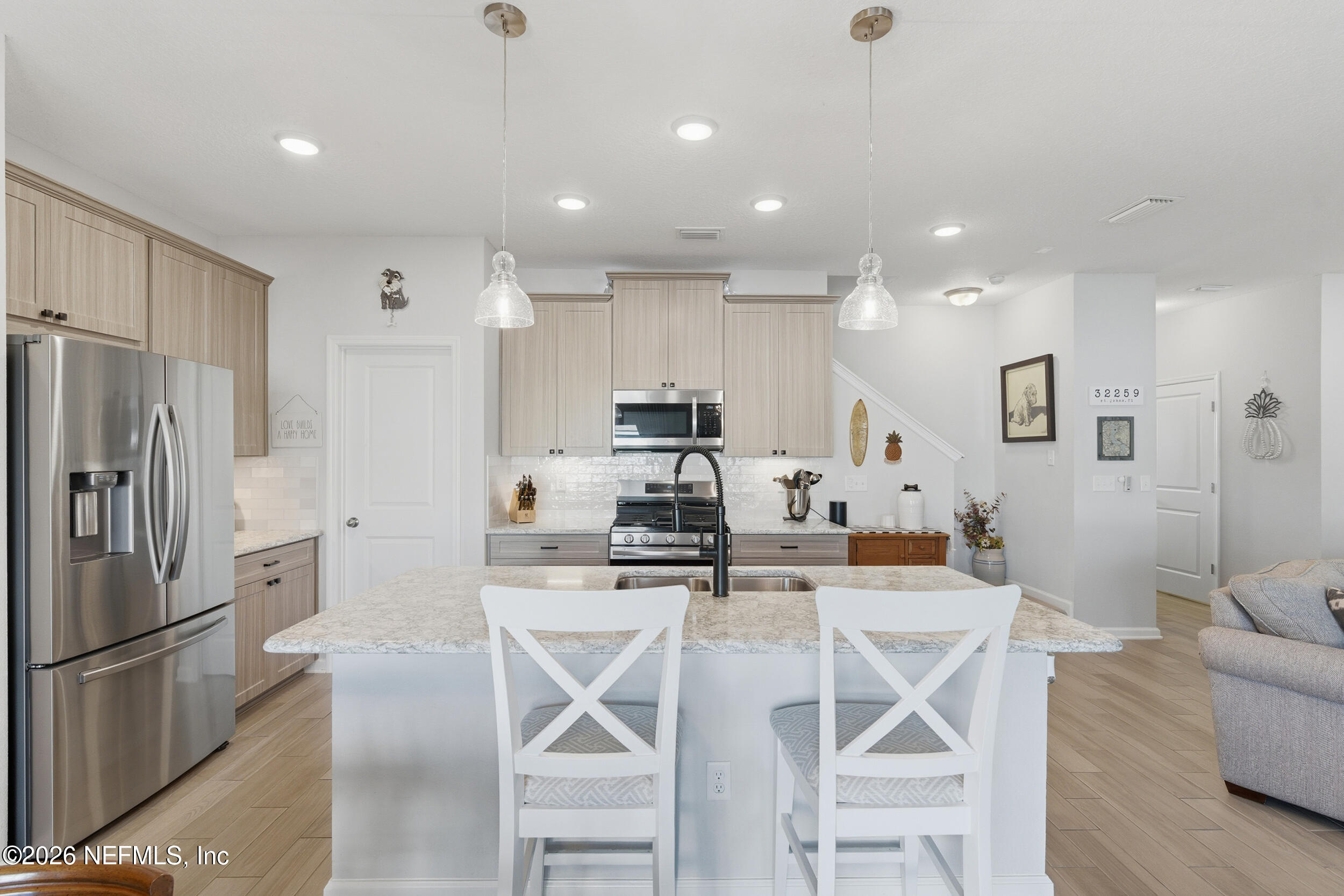 507 Narrowleaf Drive St. Johns, FL 32259 - Photo 13 of 79 a kitchen with stainless steel appliances kitchen island granite countertop a refrigerator and a stove top oven