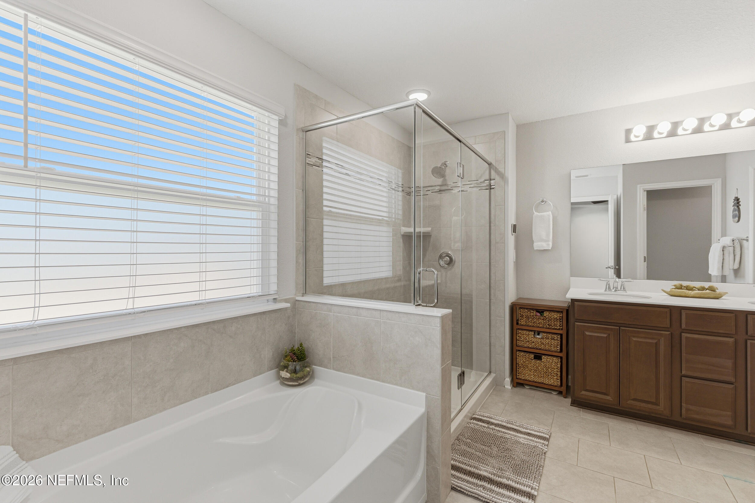 507 Narrowleaf Drive St. Johns, FL 32259 - Photo 24 of 79 a bathroom with a tub a sink and a large mirror