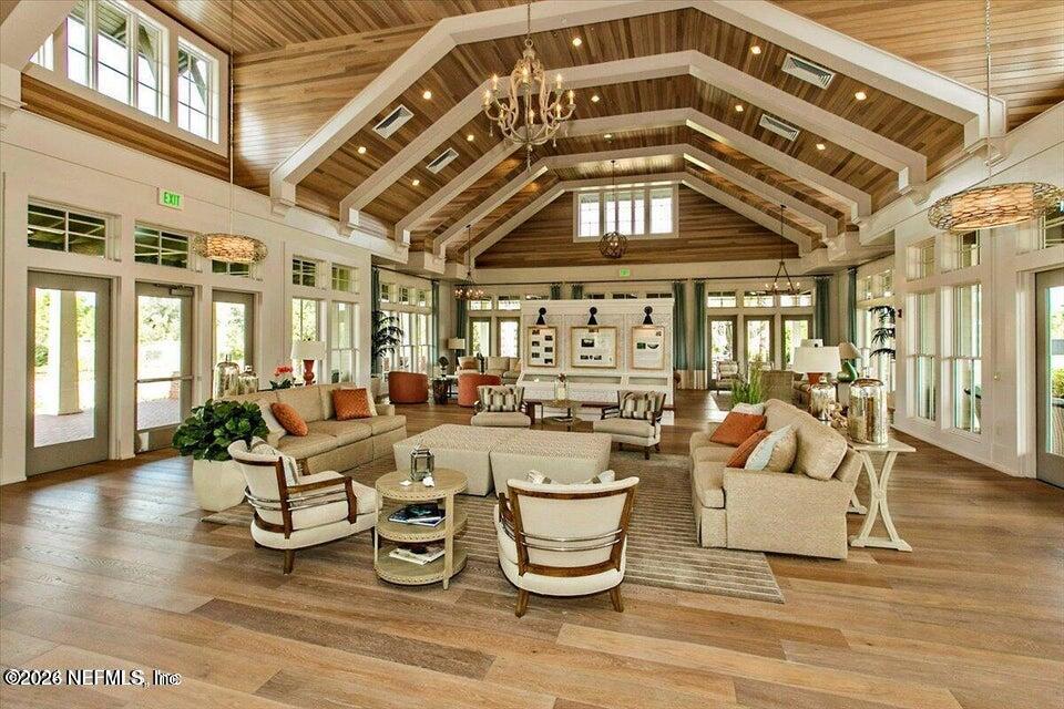 507 Narrowleaf Drive St. Johns, FL 32259 - Photo 64 of 79 a living room with lots of white furniture and a chandelier