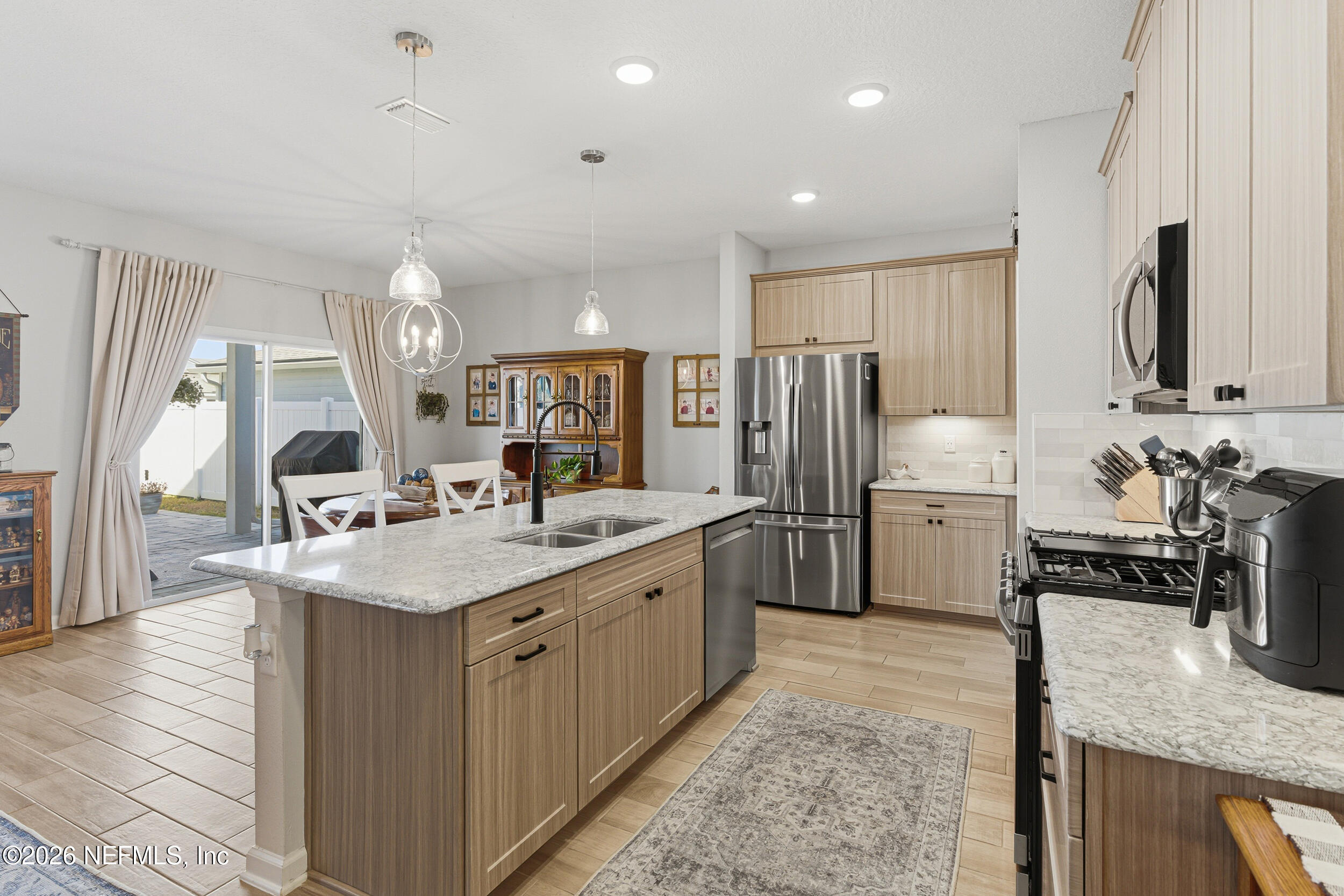 507 Narrowleaf Drive St. Johns, FL 32259 - Photo 8 of 79 a kitchen with stainless steel appliances granite countertop a sink stove and refrigerator