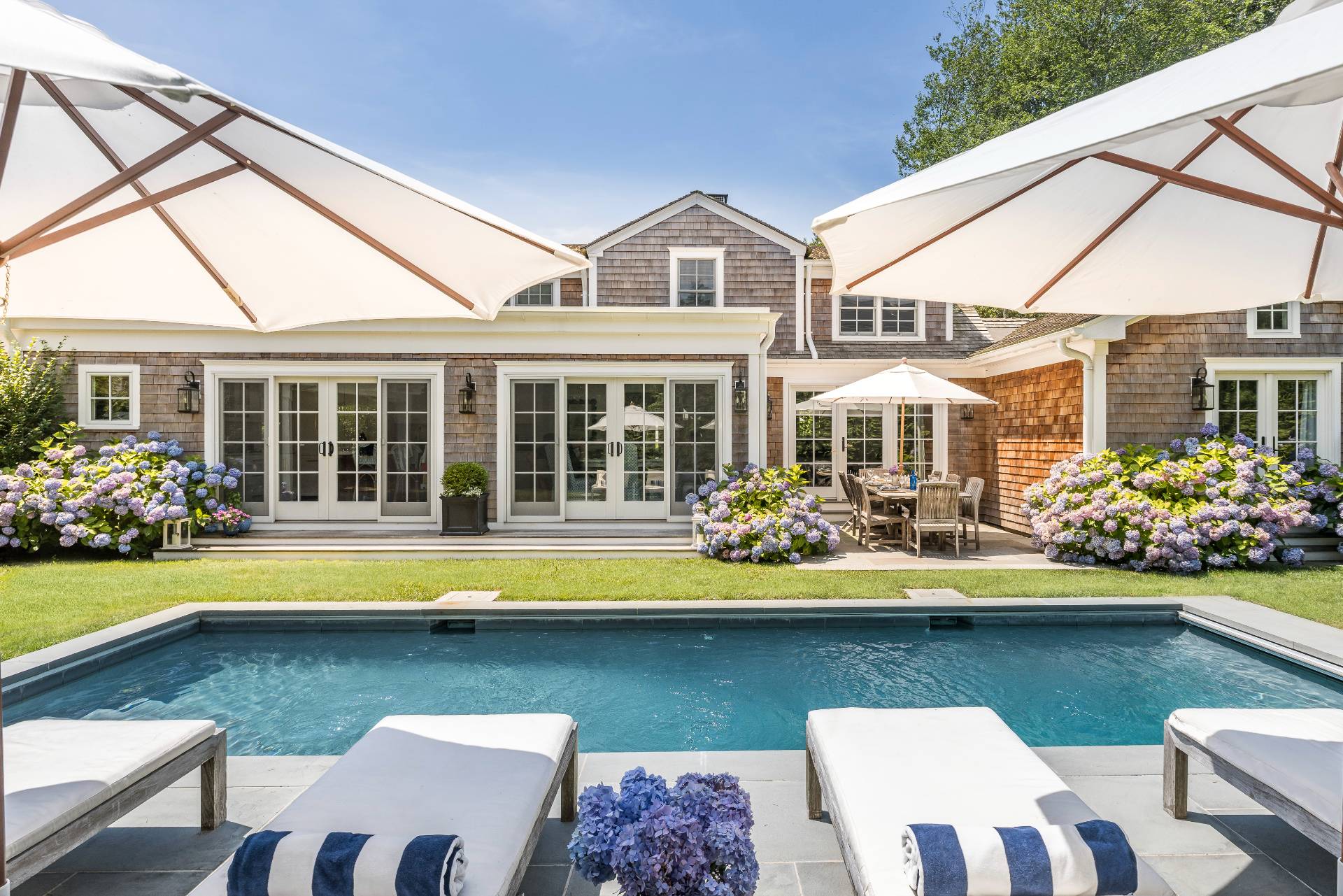 29 Cornell Road Sag Harbor, NY 11963 - Photo 22 of 26 a front view of a house with swimming pool having outdoor seating