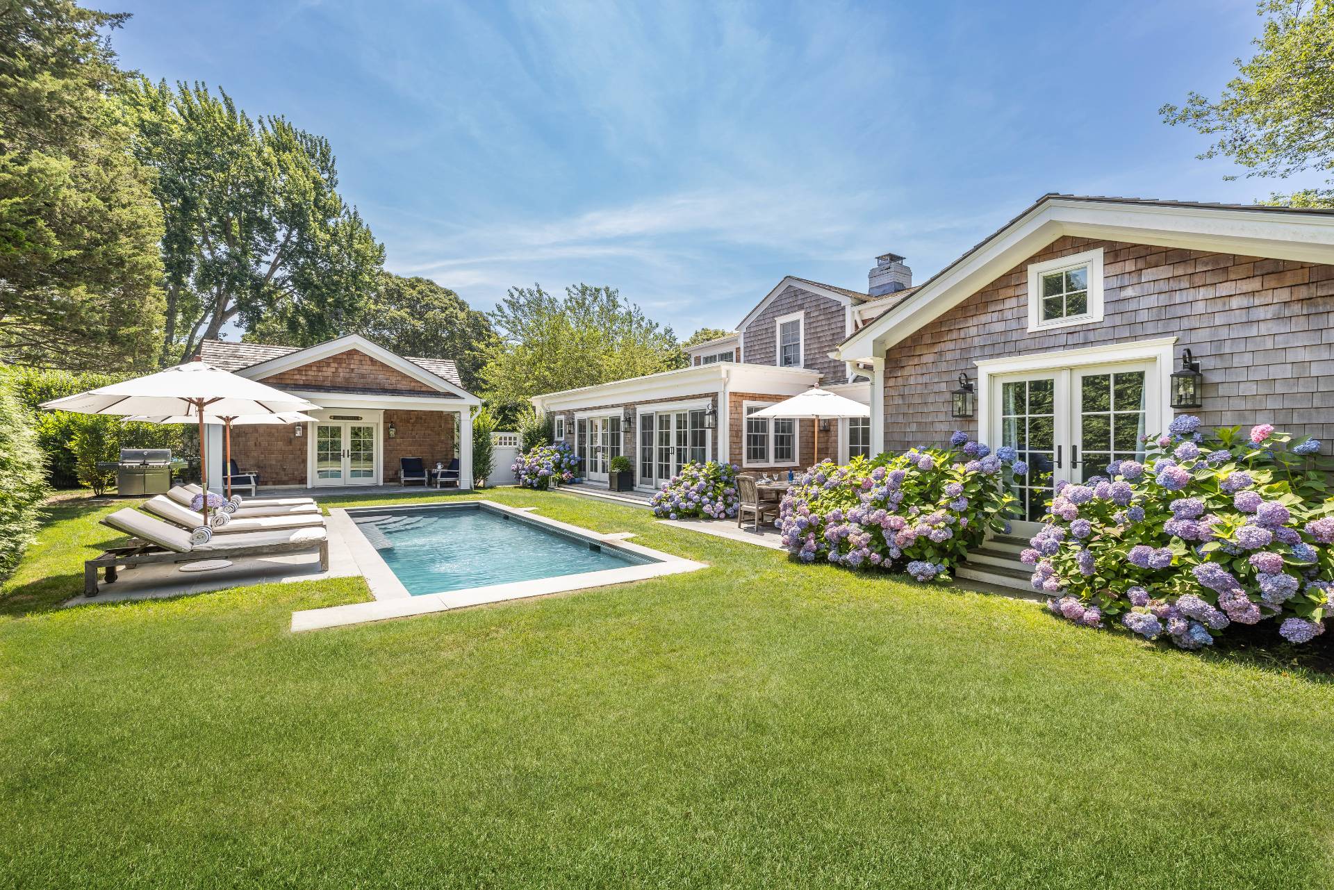 29 Cornell Road Sag Harbor, NY 11963 - Photo 23 of 26 a front view of house with yard and trees in the background