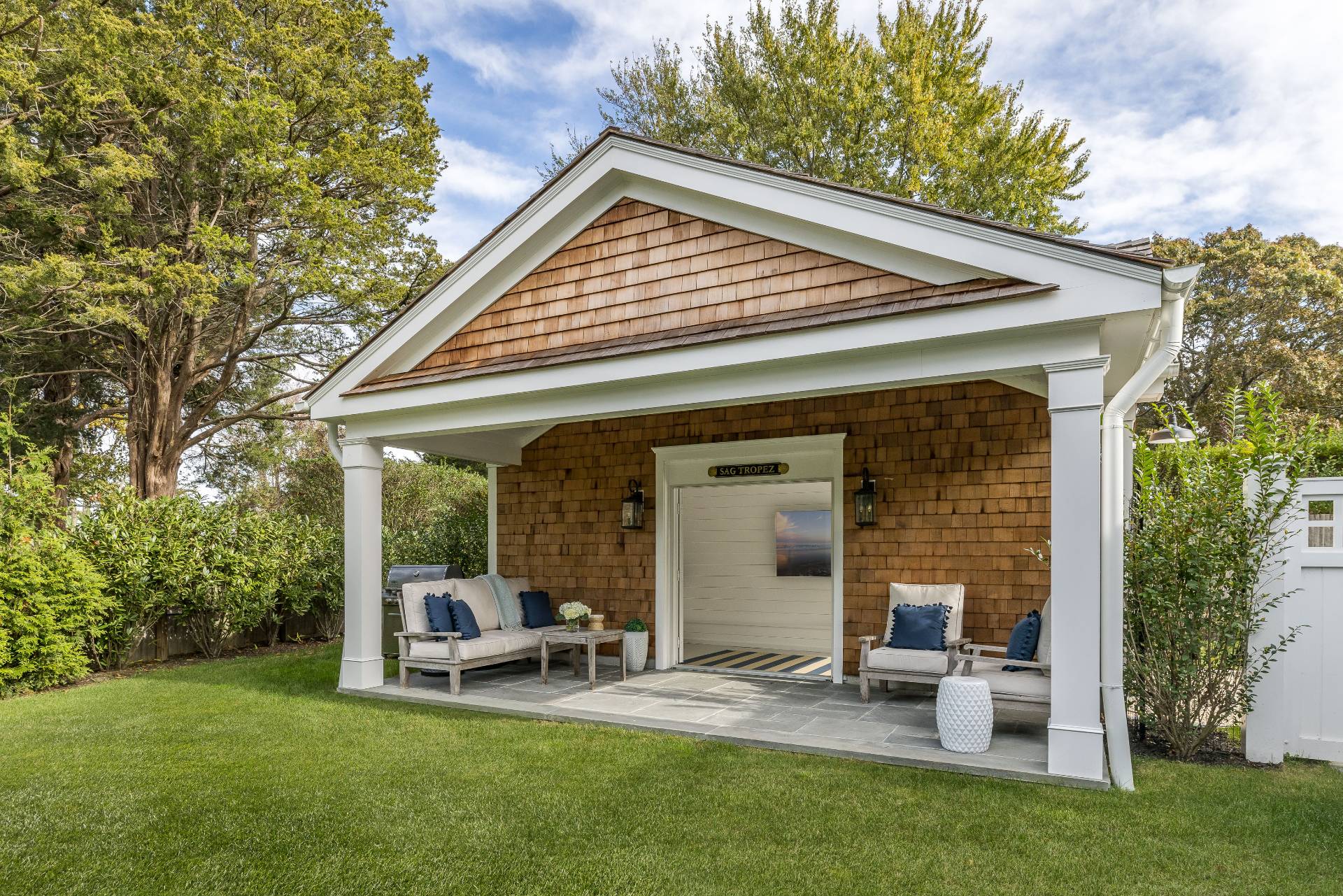 29 Cornell Road Sag Harbor, NY 11963 - Photo 24 of 26 a view of backyard with a table and chairs under an umbrella