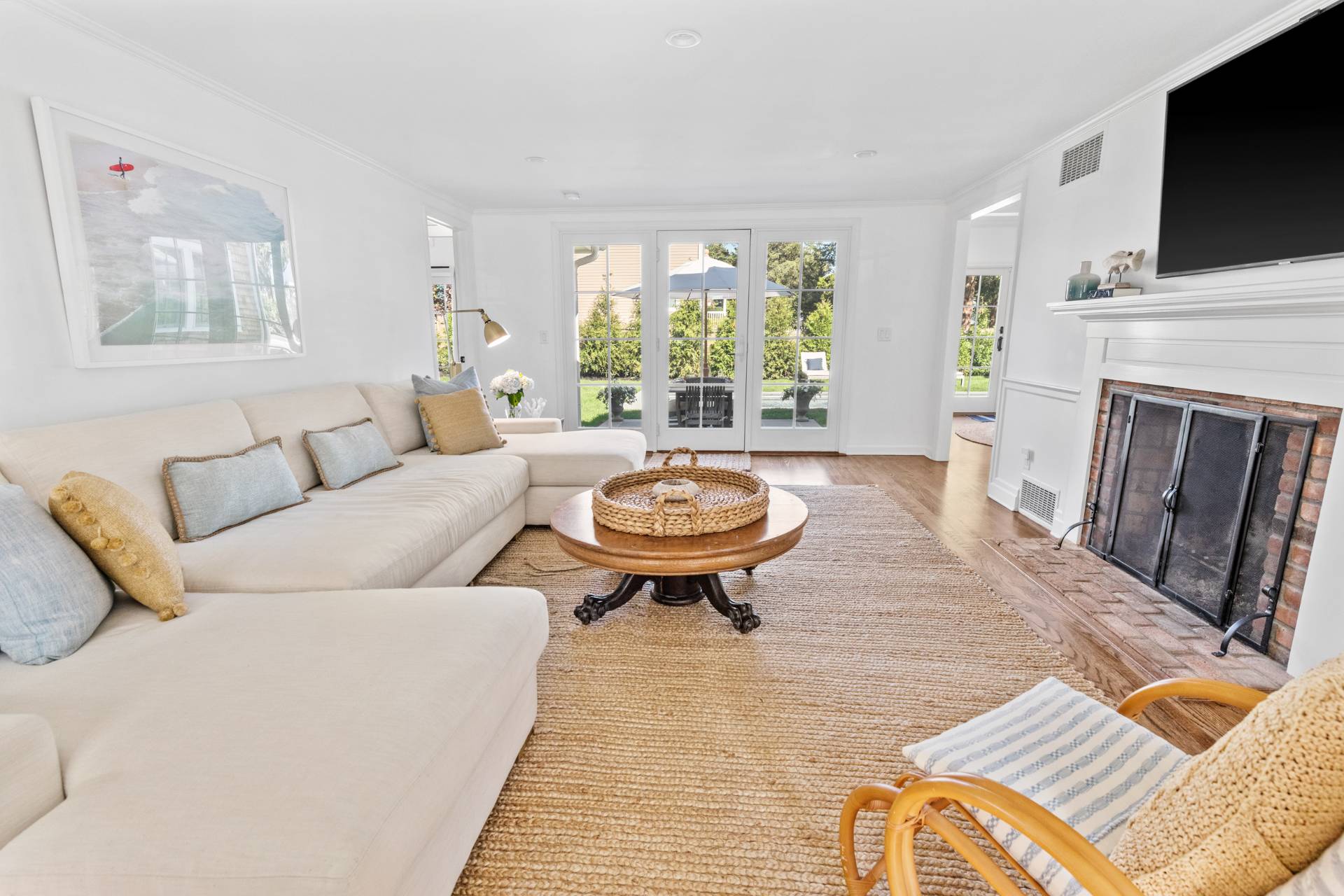 29 Cornell Road Sag Harbor, NY 11963 - Photo 5 of 26 a living room with furniture a flat screen tv and a fireplace