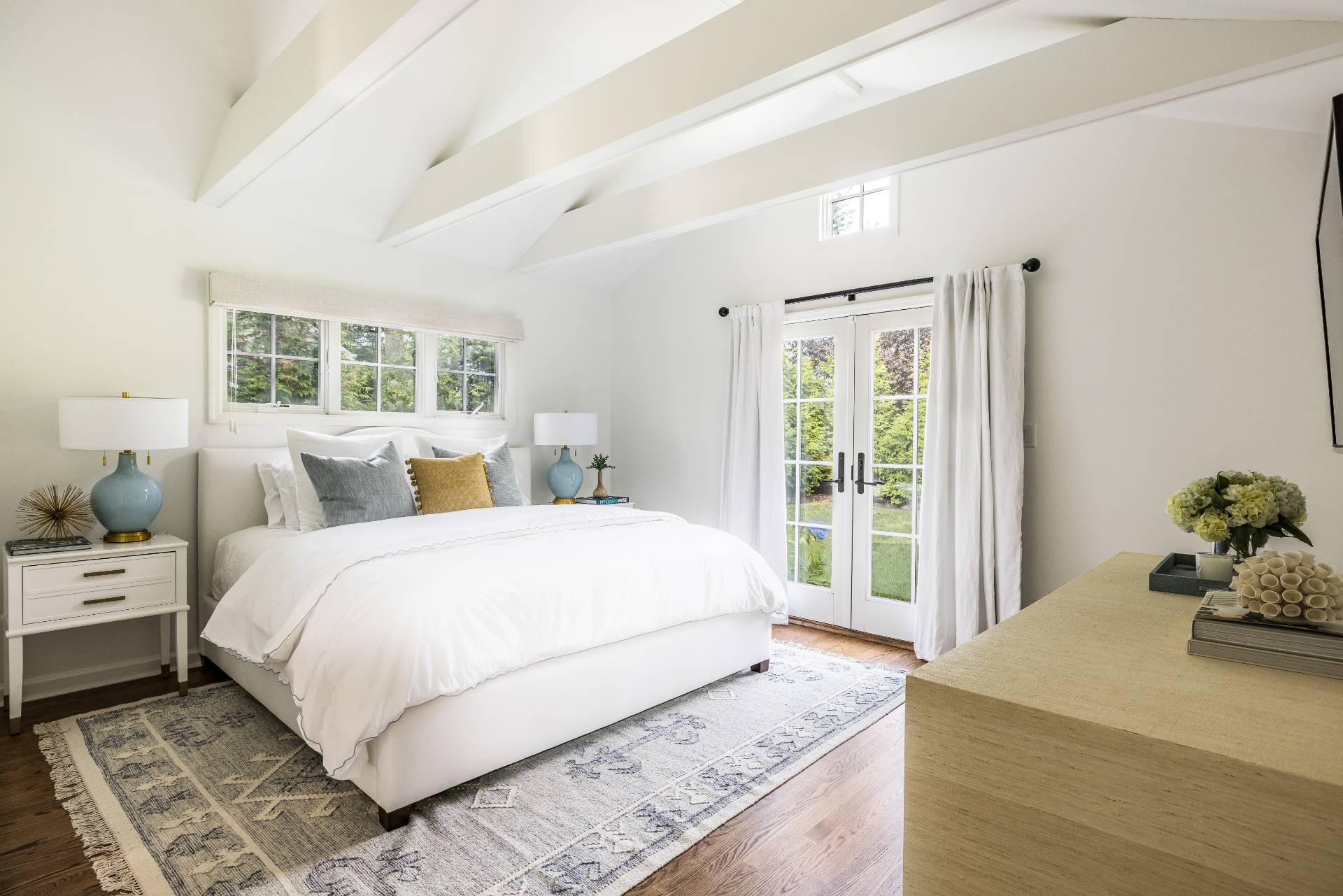 29 Cornell Road Sag Harbor, NY 11963 - Photo 9 of 26 a large bed sitting in a bedroom next to a window