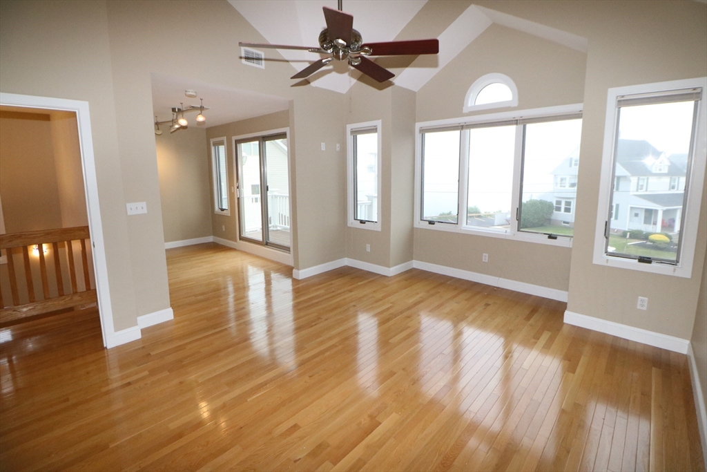141 Grovers Avenue, Unit 141 Winthrop, MA 02152 - Photo 11 of 21 a view of an empty room with wooden floor and a window