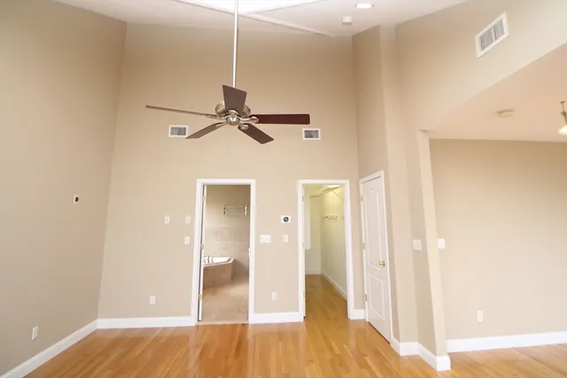a view of a room with wooden floor