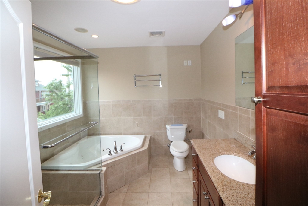 141 Grovers Avenue, Unit 141 Winthrop, MA 02152 - Photo 13 of 21 a bathroom with a sink a toilet and bathtub