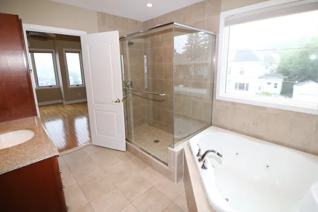 a bathroom with a bathtub and a shower