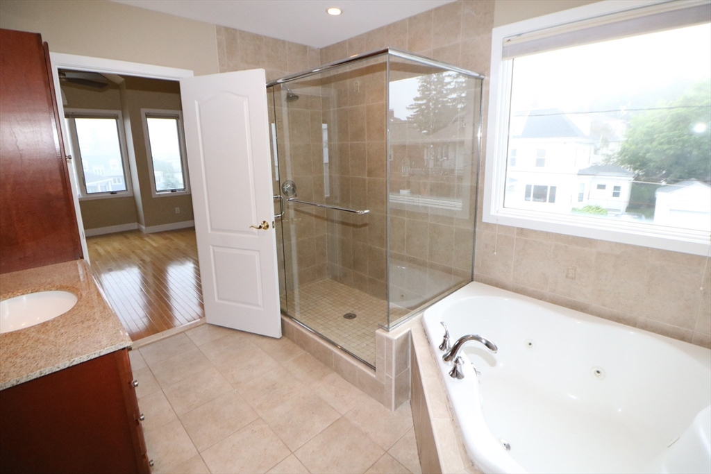141 Grovers Avenue, Unit 141 Winthrop, MA 02152 - Photo 14 of 21 a bathroom with a bathtub and a shower
