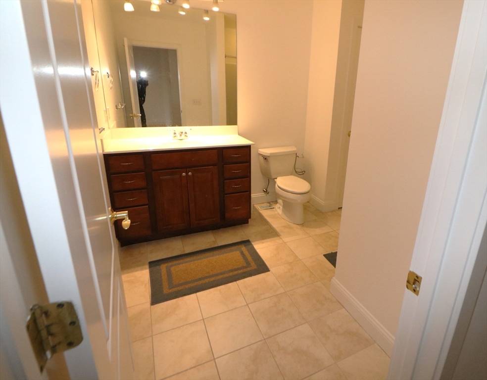 141 Grovers Avenue, Unit 141 Winthrop, MA 02152 - Photo 17 of 21 a bathroom with a sink a toilet and a mirror