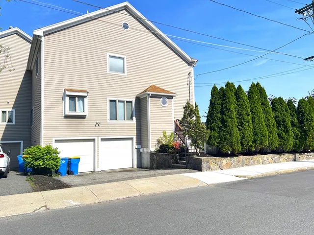 a front view of a house with a yard and a garage