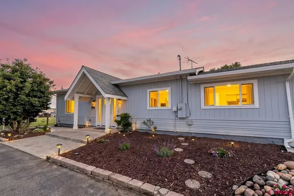 a view of house with yard and outdoor space