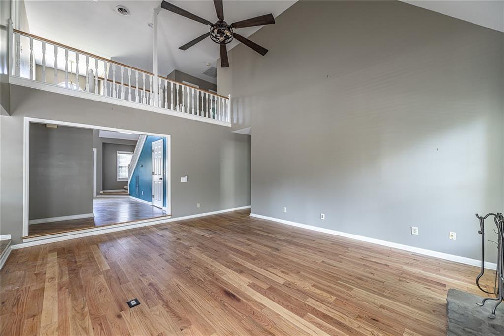 113 Warwick Way Rome, GA 30161 - Photo 10 of 49 a view of an empty room with wooden floor and a chandelier