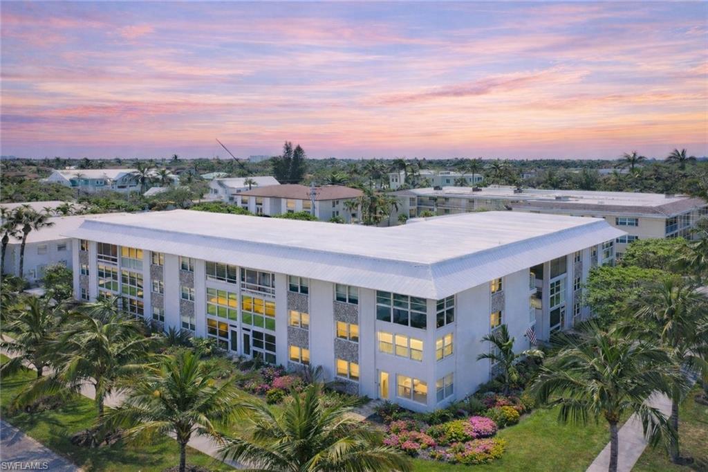 1021 3rd Street South, Unit 310 Naples, FL 34102 - Photo 23 of 27 Property at dusk featuring a view of apartment building / complex