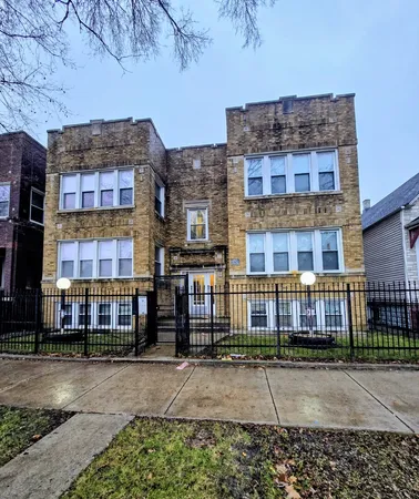 a front view of a residential apartment building with a yard