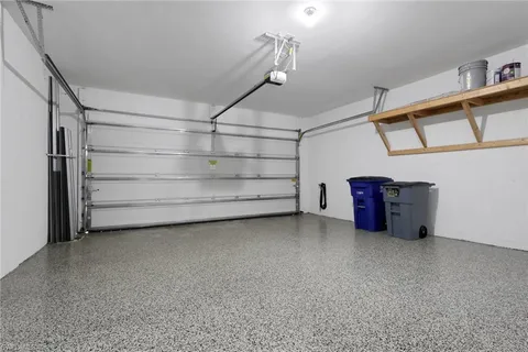a front view of a house with a garden and palm trees