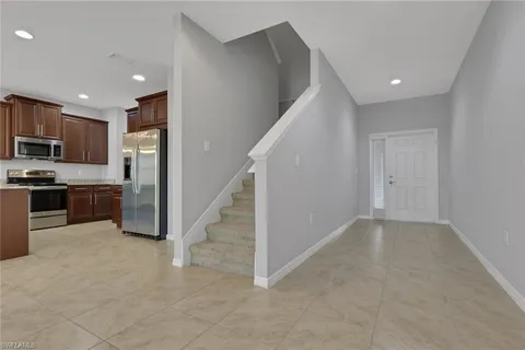 a view of a kitchen with a sink dishwasher and a refrigerator