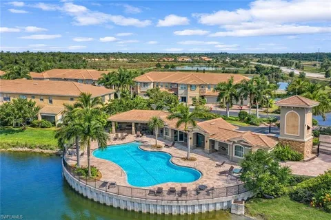 a view of a swimming pool and lounge chairs