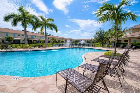 an aerial view of a house with a garden and lake view