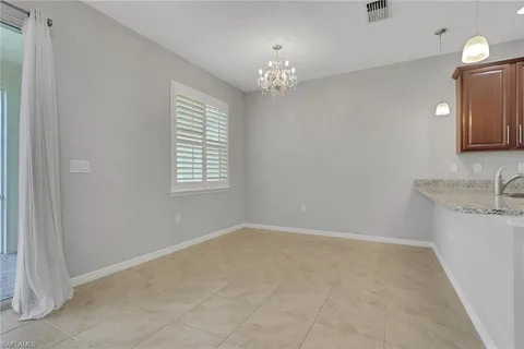 a view of a room with a chandelier fan and a window