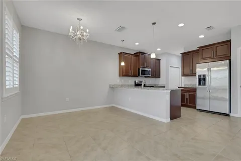 a view of a kitchen with a sink and stainless steel appliances