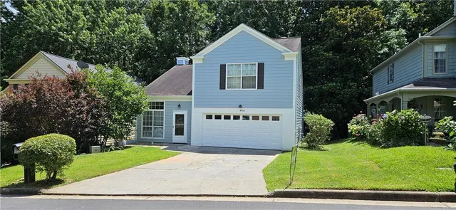 a front view of a house with garden