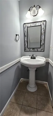 a bathroom with a sink a mirror and vanity
