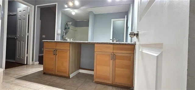 a bathroom with a double vanity sink and a mirror