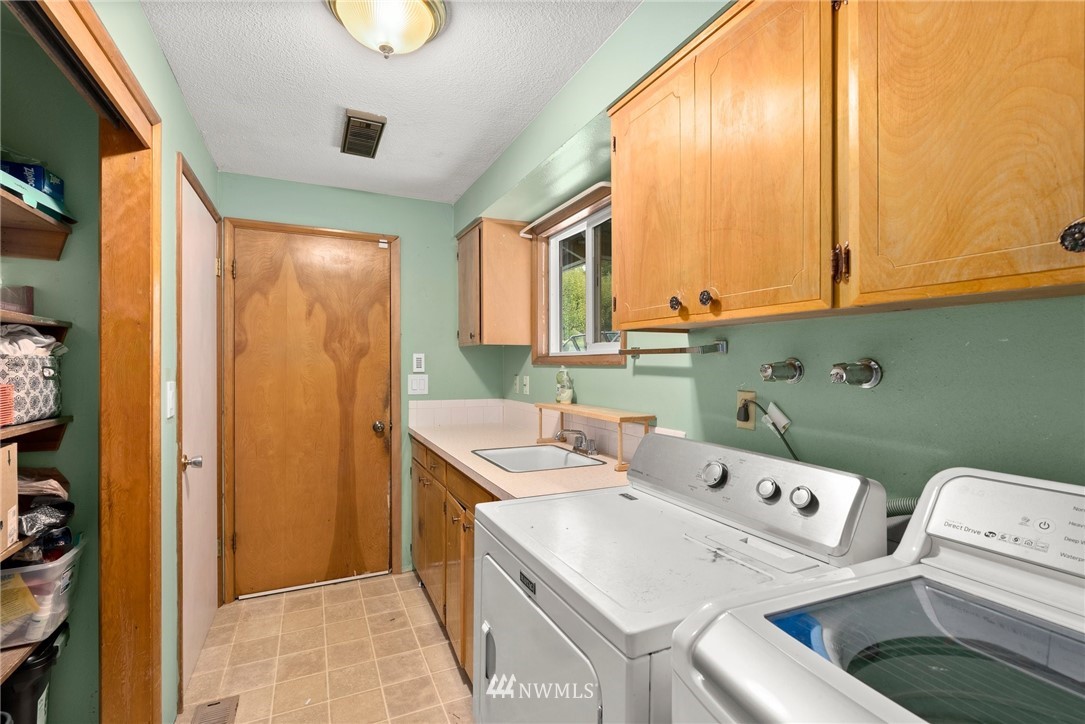 115 Kennicott Road Chehalis, WA 98532 - Photo 14 of 25 a large kitchen with stainless steel appliances granite countertop a sink and a wooden floors