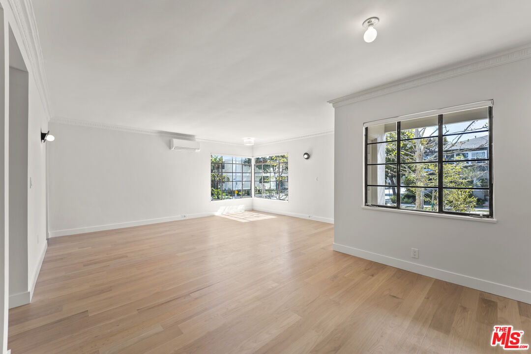 751 18th Street, Unit B Santa Monica, CA 90403 - Photo 1 of 24 an empty room with wooden floor and windows