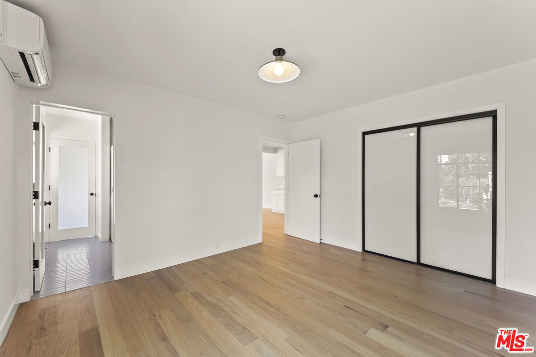 751 18th Street, Unit B Santa Monica, CA 90403 - Photo 14 of 24 a view of an empty room with wooden floor and a window
