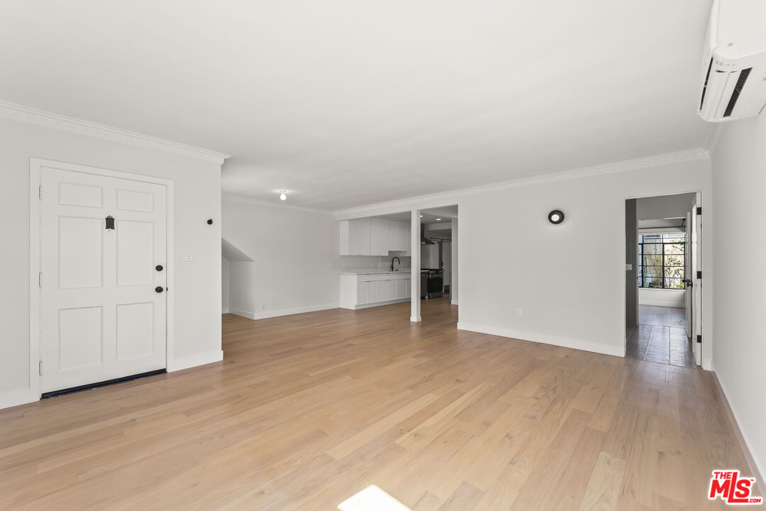 751 18th Street, Unit B Santa Monica, CA 90403 - Photo 4 of 24 a view of an empty room with wooden floor and a window