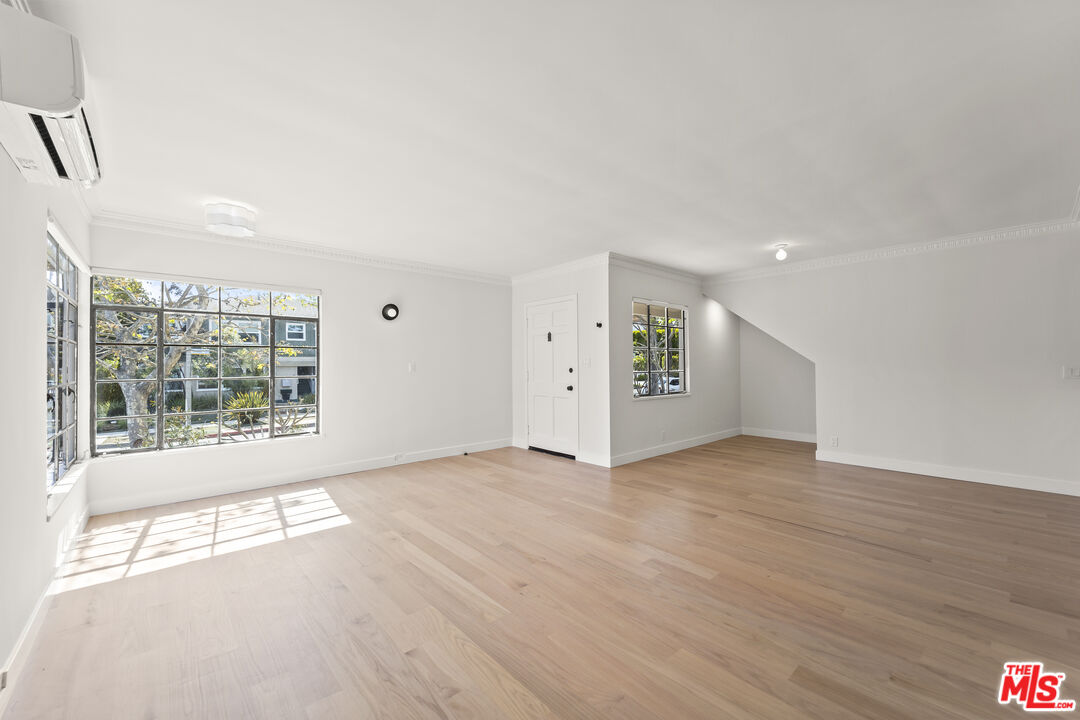751 18th Street, Unit B Santa Monica, CA 90403 - Photo 5 of 24 a view of an empty room with wooden floor and a window